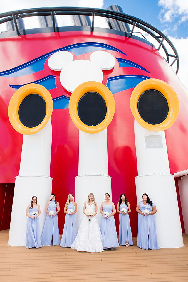 Bridesmaids by the famous red, white and yellow Mickey Mouse stack on Disney Cruise Line. Disney Wish wedding photos by Mikkel Paige Photography.