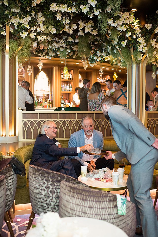 Guests at a wedding reception in The Bayou on Disney Cruise Line. Disney Wish wedding photos by Mikkel Paige Photography.