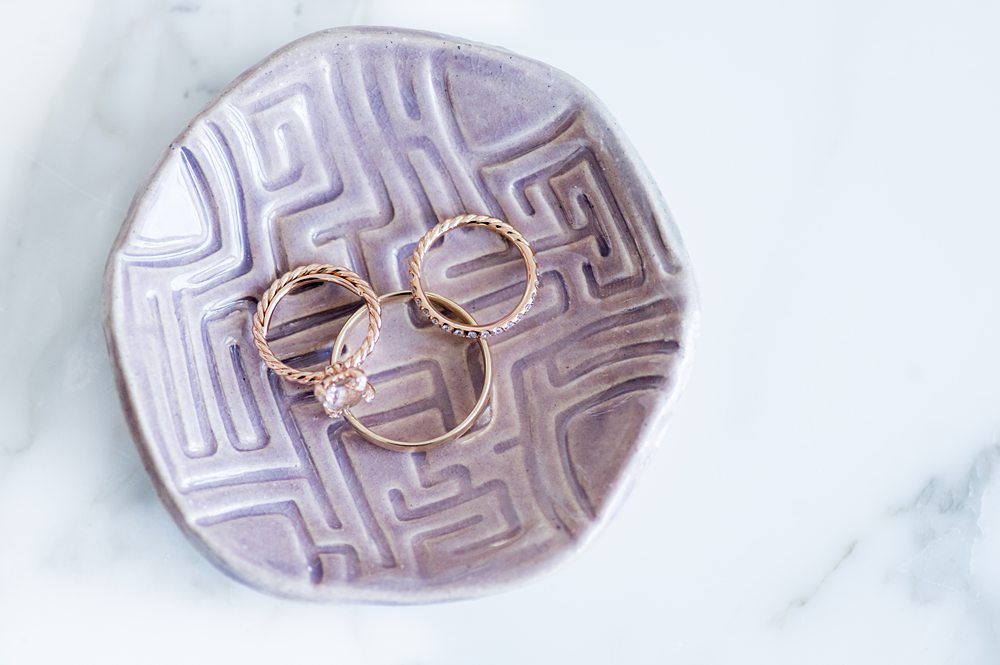 Rings in a Mickey Mouse head shape on a purple ring dish for a Disney Wish cruise wedding by Mikkel Paige Photography.