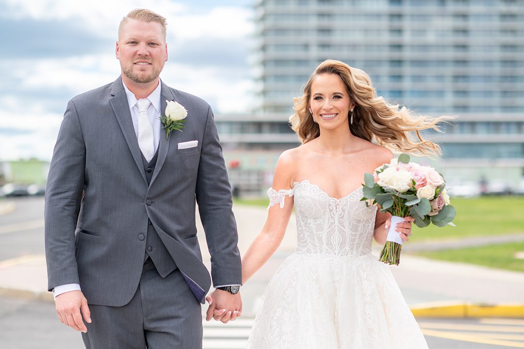 Bride and groom in front of Asbury Park convention center, NJ on their wedding day. Photos by Mikkel Paige Photography.