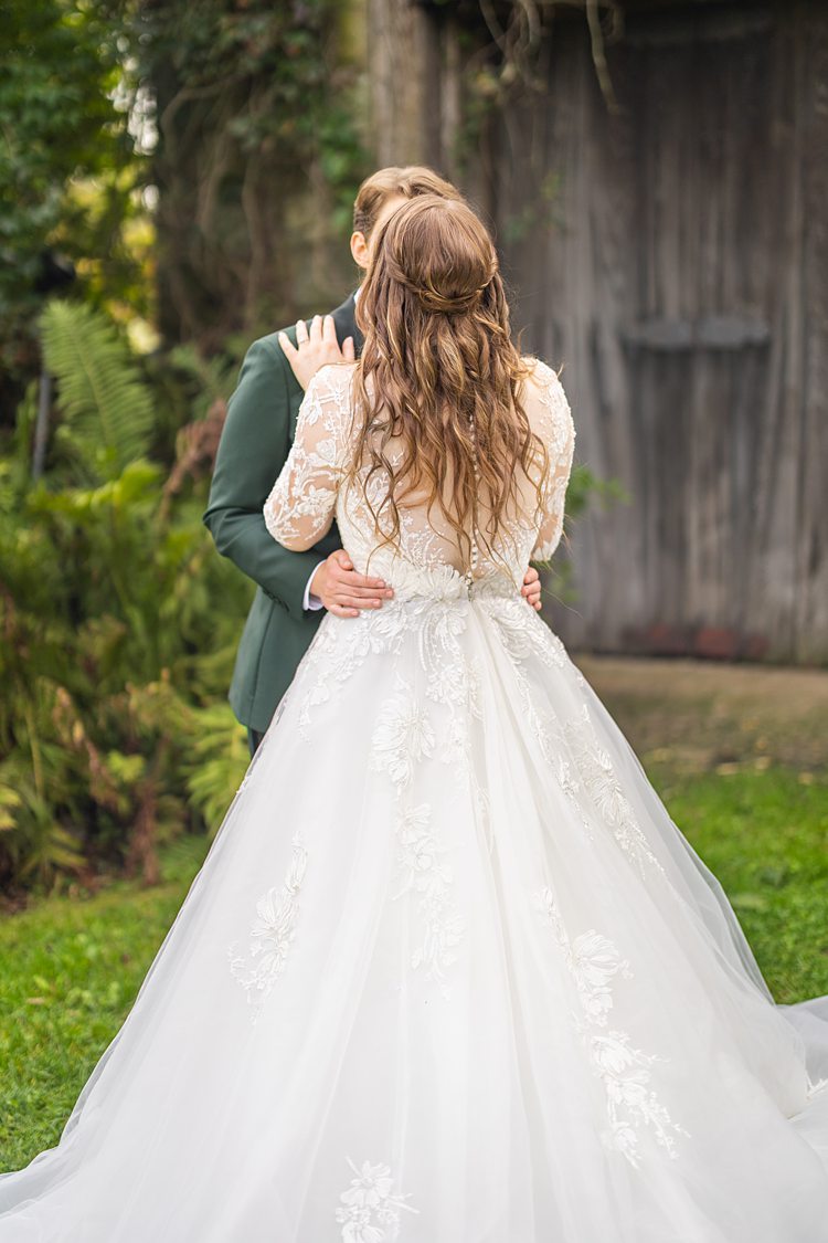 The back of the dres of a bride as she kisses her partners for a wedding at Blue Hill Stone Barns