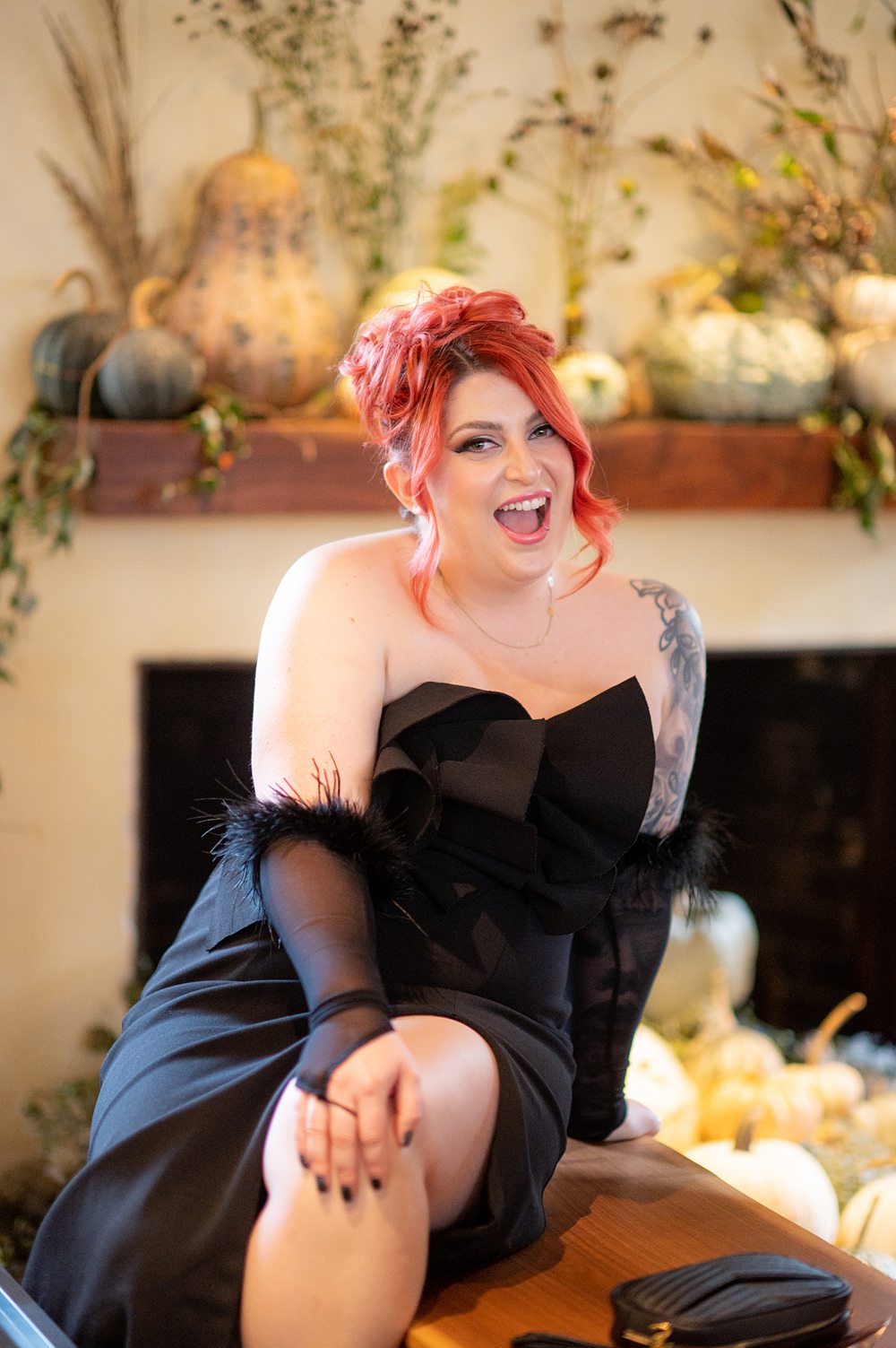 A woman in a black dress smiling for camera at Blue Hill Stone Barns.