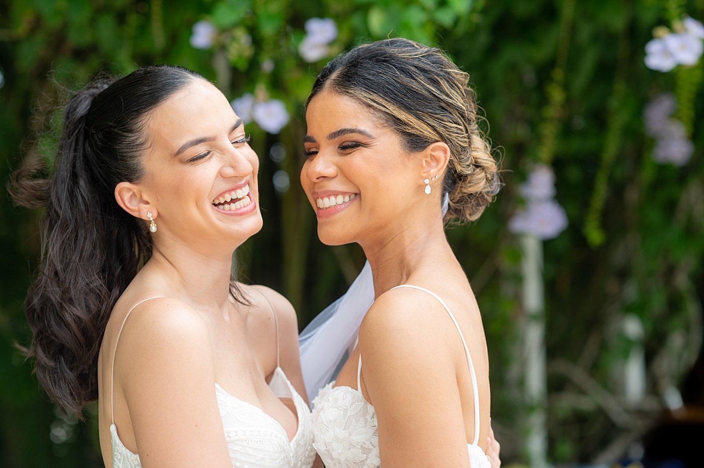 Two brides laughing at their same sex wedding at a private villa at Casa de Campo in the Dominican Republic.