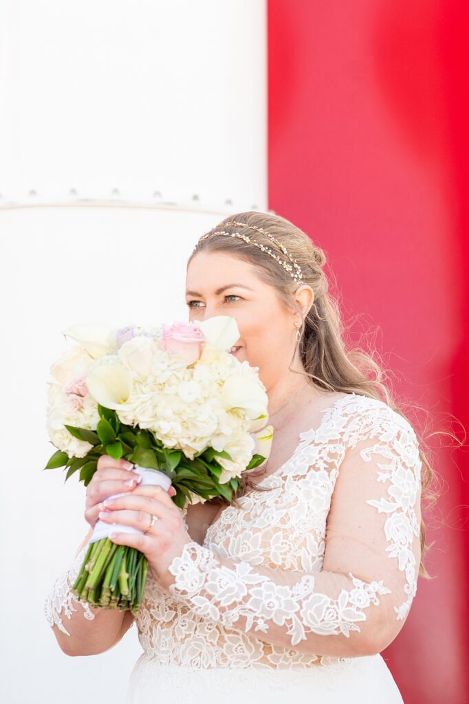 Bride smelling her wedding bouquet during her wedding on Disney Wish cruise line ship.