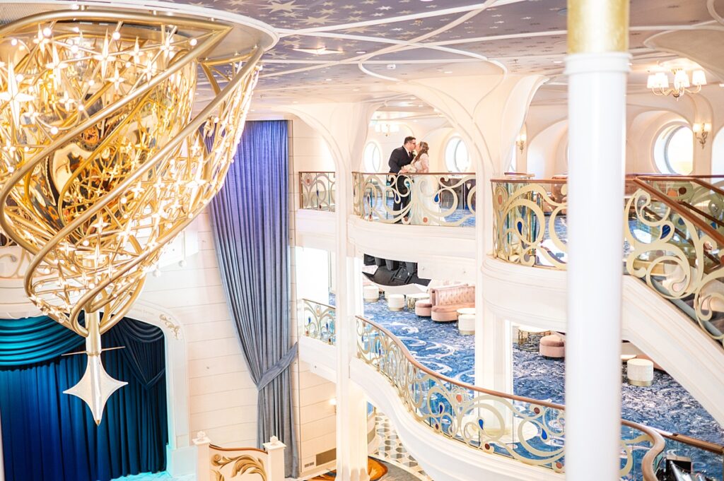 Bride and groom on the balcony of the Grand Hall on Disney Wish for their cruise line wedding.