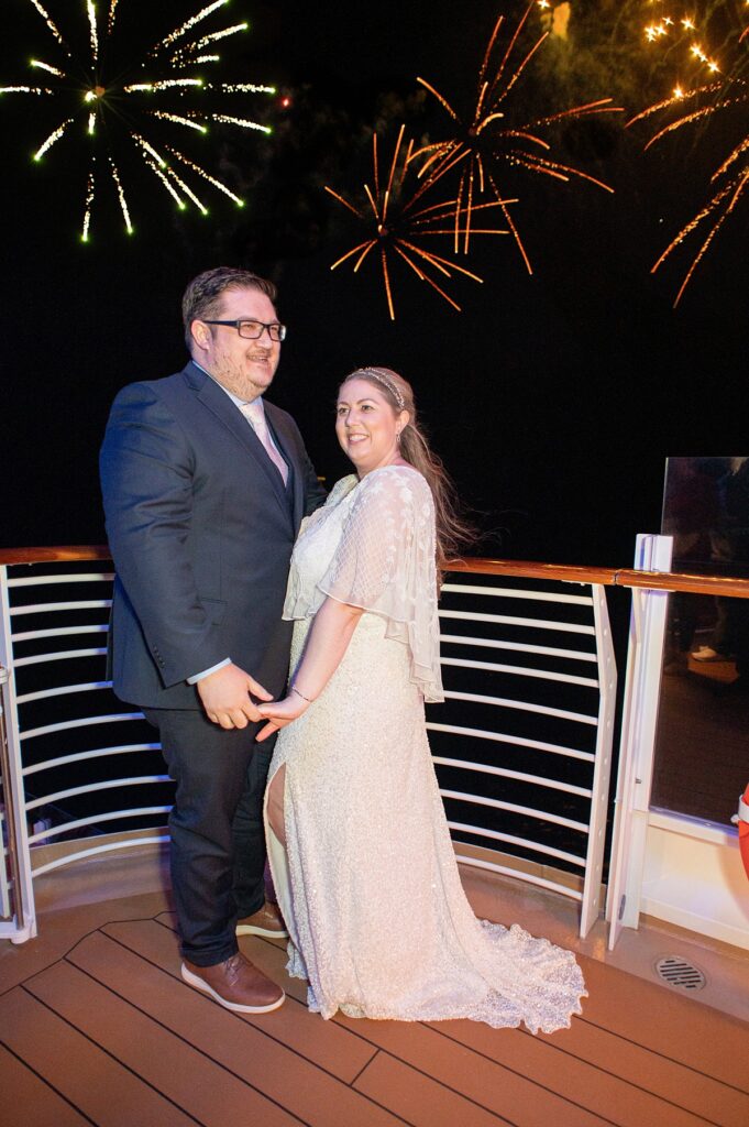 Bride and groom on their wedding day during the fireworks on a Disney Cruise.