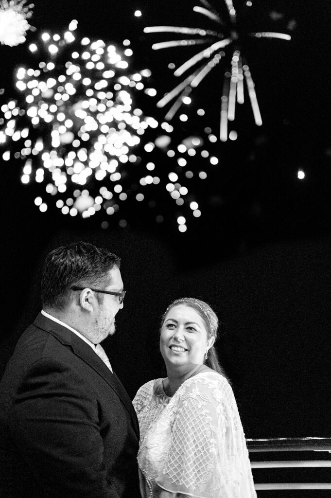 Bride and groom on their wedding day during the fireworks on a Disney Cruise.