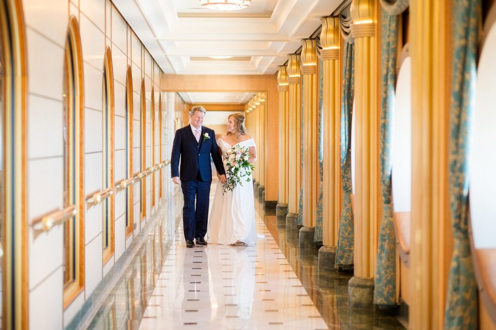Couple walking in a hallway on Disney Fantasy cruise ship.