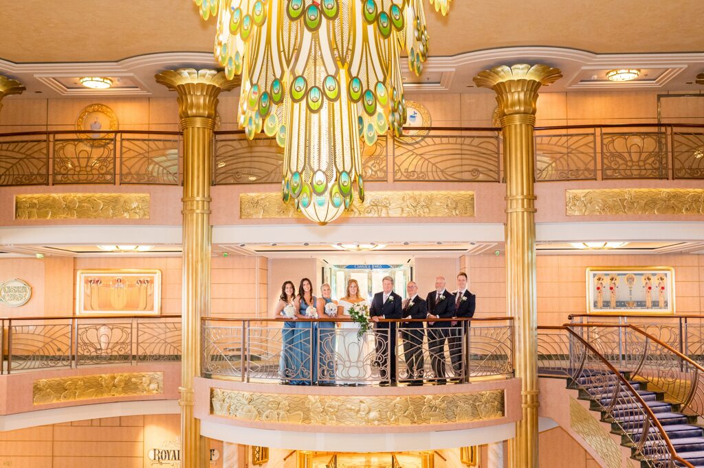 Wedding party on the grand atrium deck 4 balcony on Disney Fantasy during a cruise line wedding.