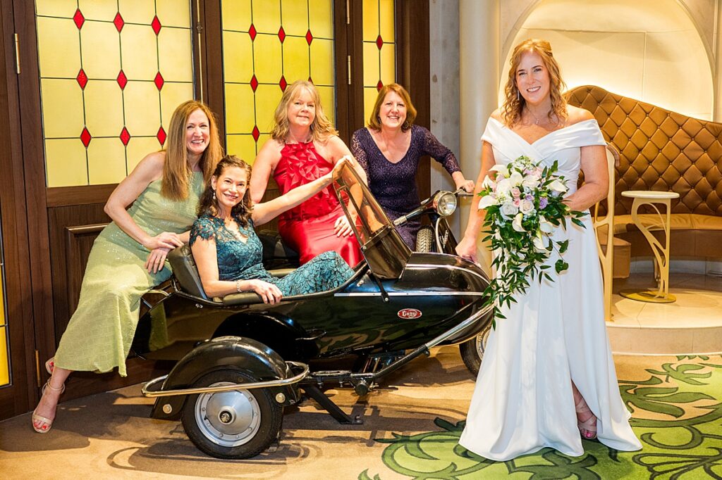 Group of women posing for a photo at La Piazza on Disney Fantasy for a cruise wedding.