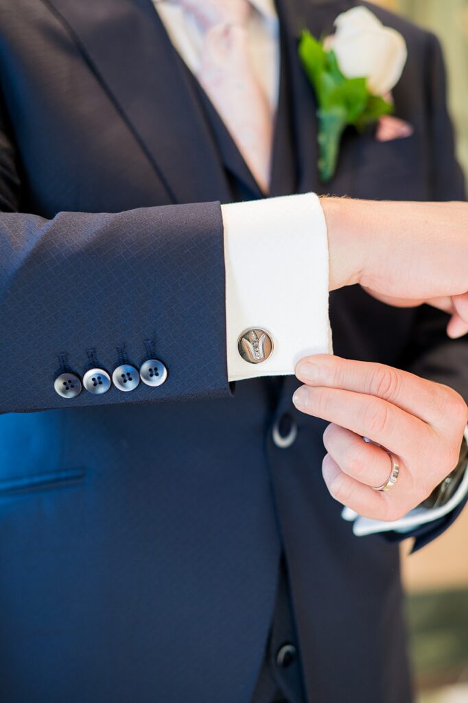 The groom's cufflinks with a navy suit for a Disney Cruise Line wedding.